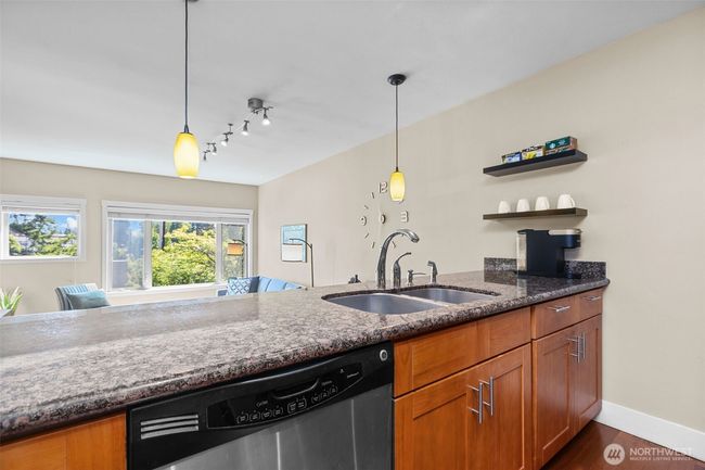 I love the pendant lighting over the eating bar and the shelves the seller added for convenience. | Image 17