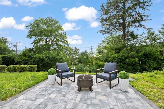 View of patio featuring an outdoor fire pit | Image 35