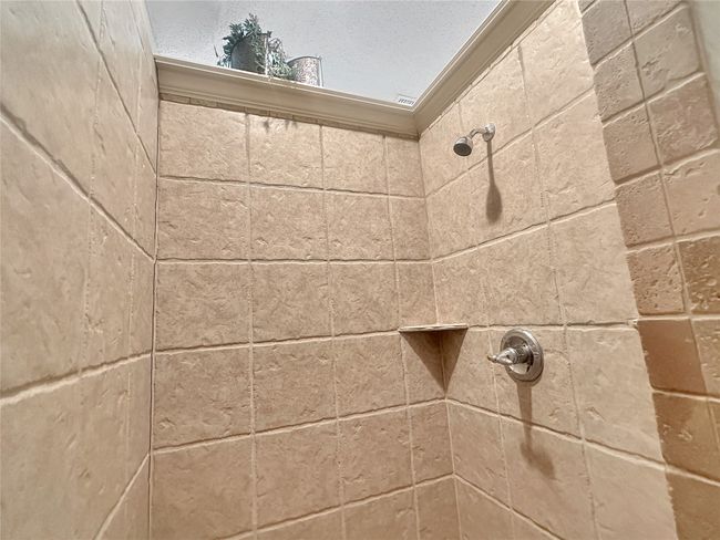 Bathroom view of a tile shower | Image 9