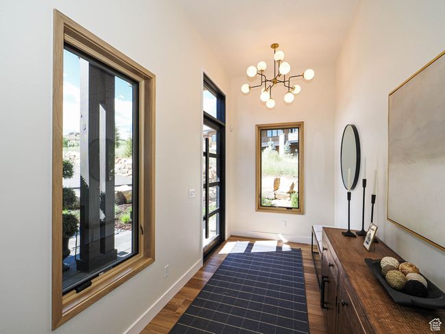 Entryway featuring a chandelier and dark wood finished floors | Image 22