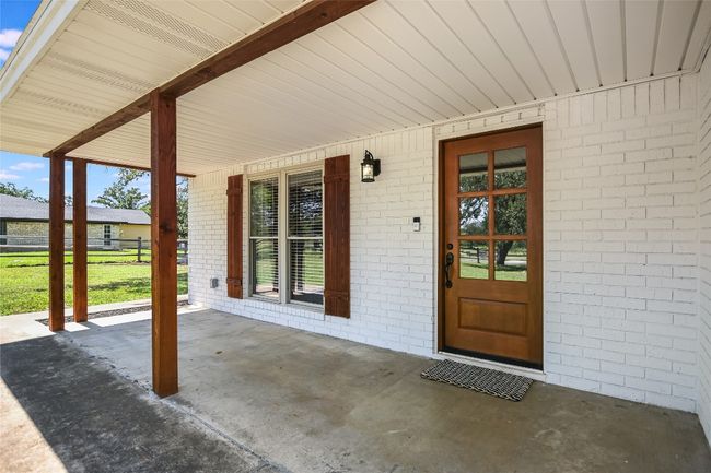 Doorway to property with a porch and brick siding | Image 4