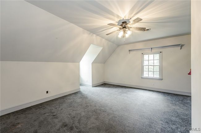 Bonus room featuring carpet flooring, a ceiling fan, vaulted ceiling, and baseboards | Image 33