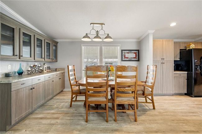 Dining area with light wood-type flooring, ornamental molding, and recessed lighting | Image 12