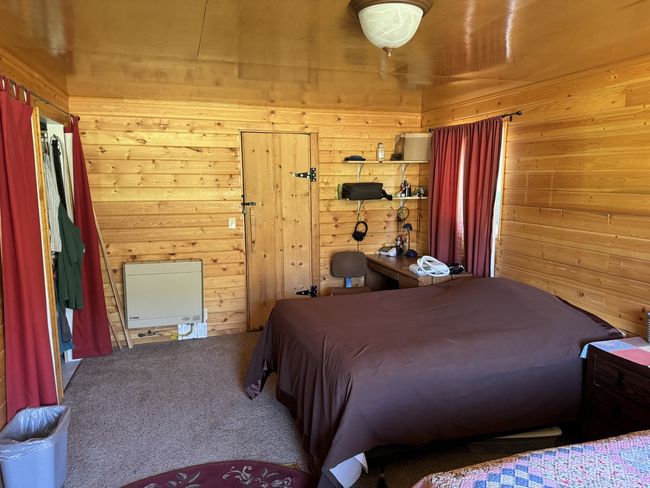 Carpeted bedroom featuring wooden walls | Image 6