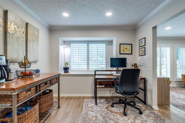 Breakfast nook converted to an office and coffee area. These 2 rooms have beautiful white shutters. | Image 6