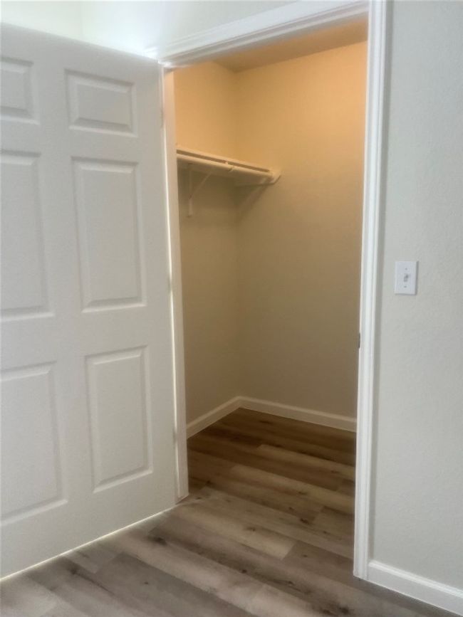 Spacious closet featuring wood finished floors | Image 15