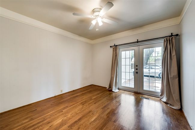 Spare room with wood finished floors, a ceiling fan, french doors, and crown molding | Image 19