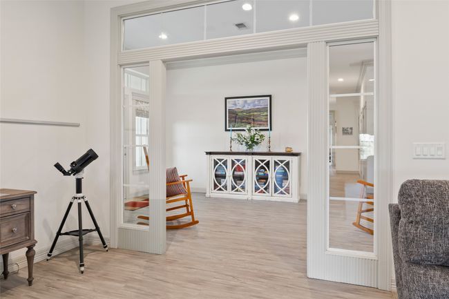 Sitting room with light wood finished floors and visible vents | Image 16