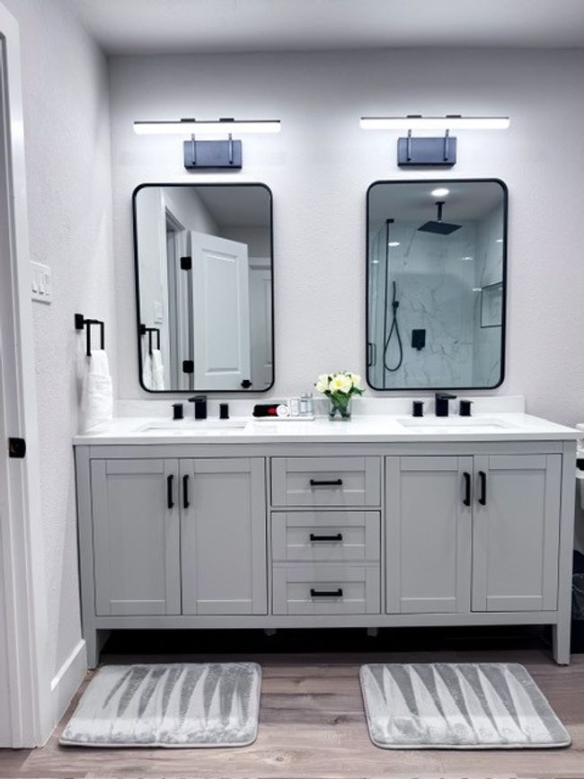 Bathroom featuring a shower, vanity, and hardwood / wood-style flooring | Image 12