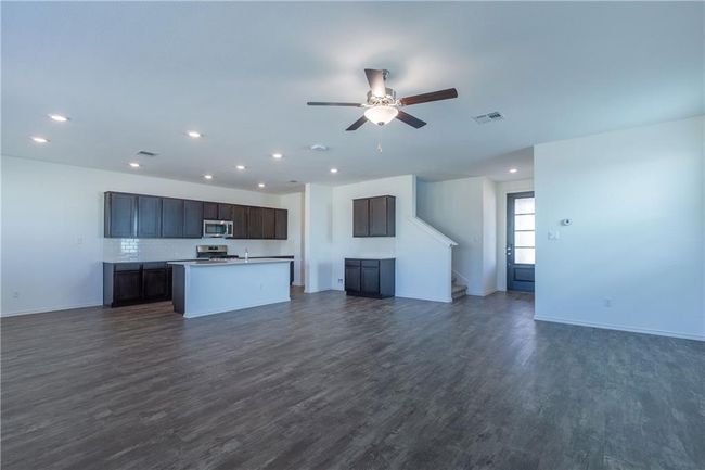 Unfurnished living room featuring recessed lighting, dark wood-type flooring, a ceiling fan, and stairs | Image 16