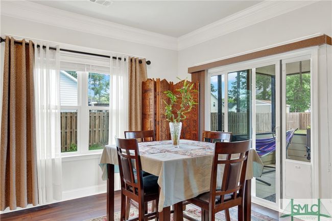 Breakfast room with sliding glass door s to the screened porch and privacy fenced backyard | Image 14