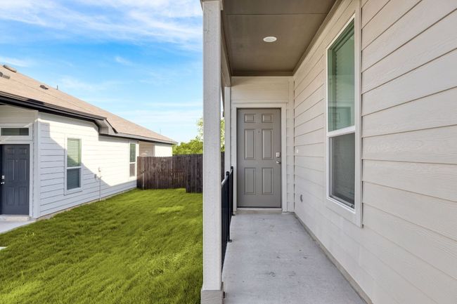 Doorway to property featuring a yard and fence | Image 7