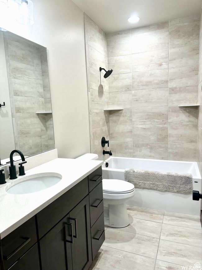Full guest bathroom on main with upgraded floor to ceiling tile shower and oversized bathtub | Image 20