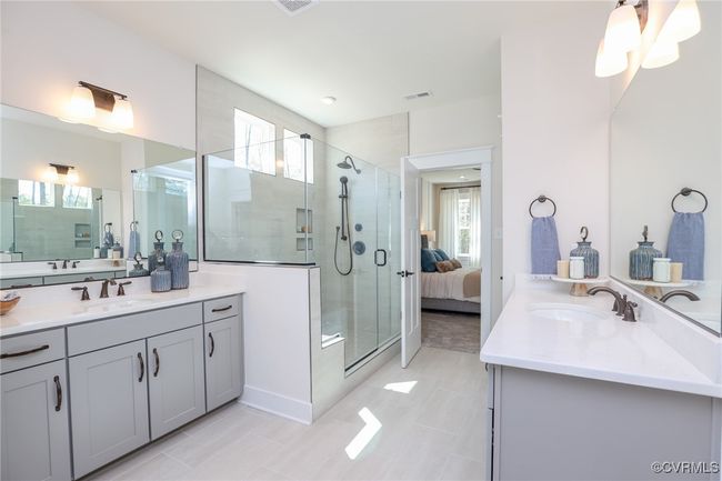 Primary bath with luxury shower, double vanity, linen closet and water closet. | Image 14