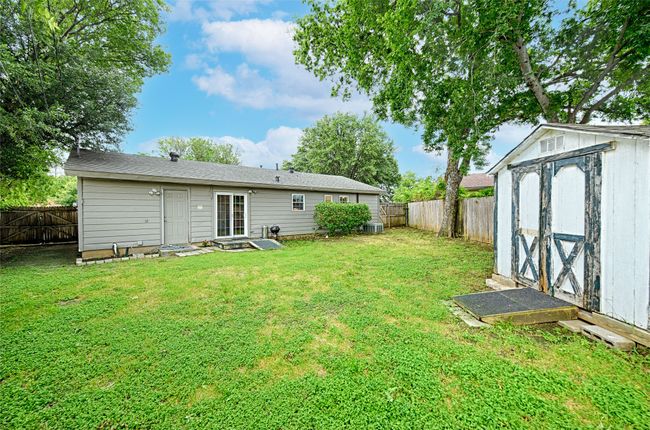 View back to house, with doors to the garage and patio doors into the house. | Image 22