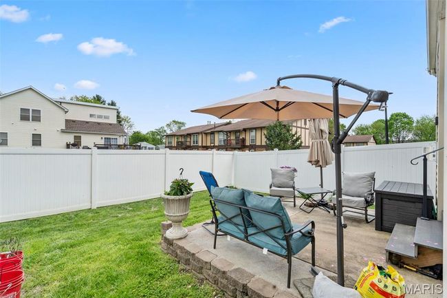 View of yard featuring a fenced backyard and a patio area | Image 20