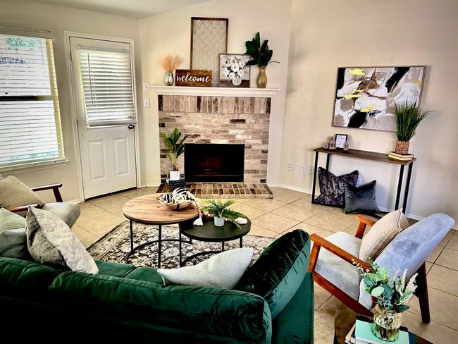 Tiled living area with plenty of natural light and a fireplace | Image 8