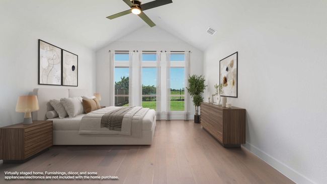 Bedroom with a ceiling fan, visible vents, wood finished floors, baseboards, and lofted ceiling with beams | Image 4
