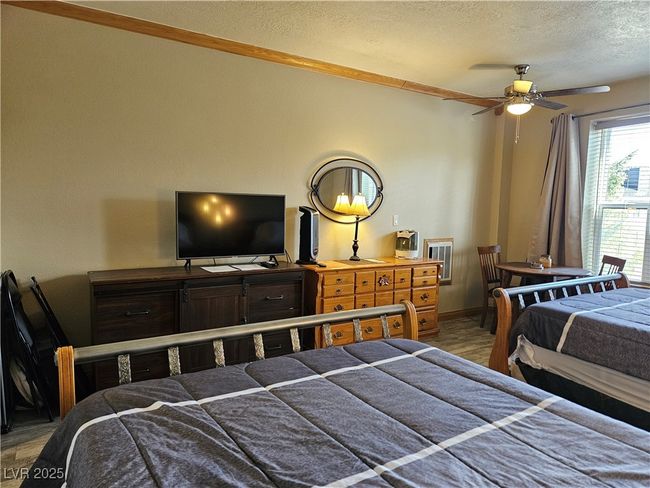 Bedroom featuring a textured ceiling and light wood-style floors | Image 15
