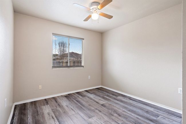 Empty room with wood finished floors and ceiling fan | Image 12