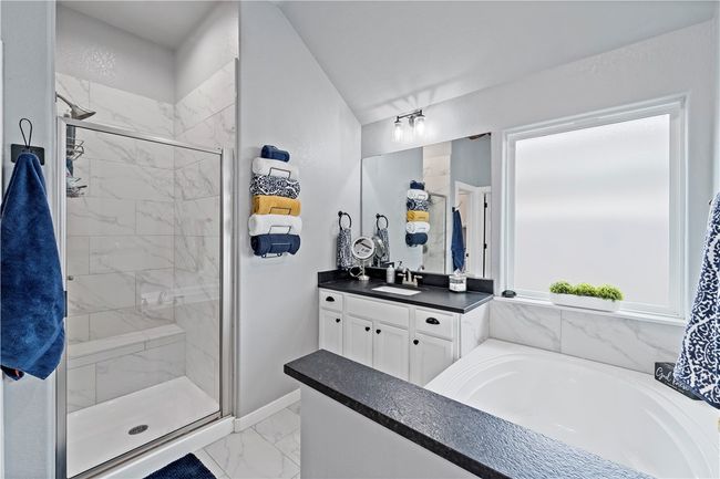 Bathroom featuring vanity, baseboards, a shower stall, marble finish floor, and a garden tub | Image 22