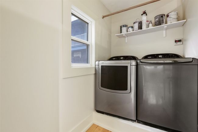Laundry room with separate washer and dryer and light wood-type flooring | Image 21