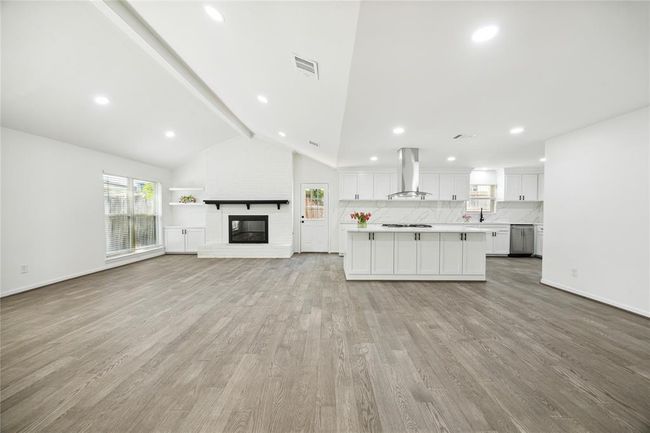 A look at the large open-concept kitchen and den space. | Image 7