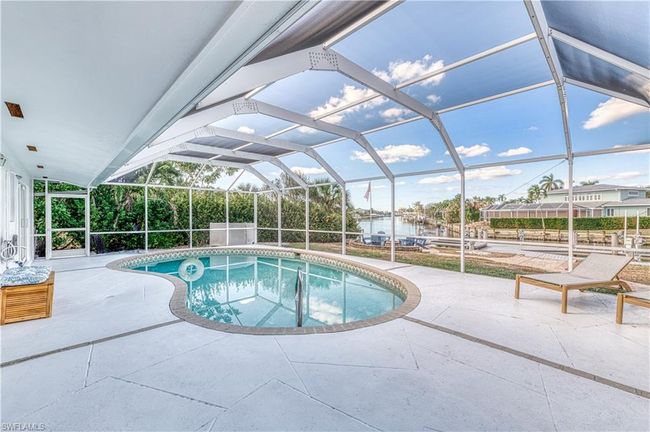 Pool featuring a patio area and glass enclosure | Image 6