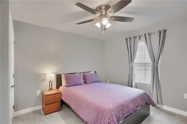 Bedroom to the right of the entry with ample closet space and bright natural light. | Image 13