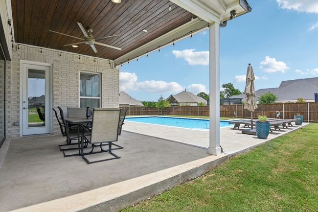 View of pool featuring ceiling fan, a patio area, and a fenced backyard | Image 36