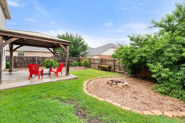 Fenced backyard with a gazebo, an outdoor fire pit, and a patio area | Image 29