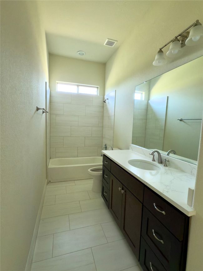 Full bathroom with vanity, toilet, shower / bathtub combination, and tile patterned flooring | Image 36
