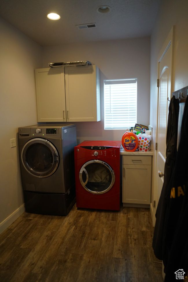 Laundry room featuring cabinet space, dark wood-style flooring, visible vents, and separate washer and dryer | Image 21