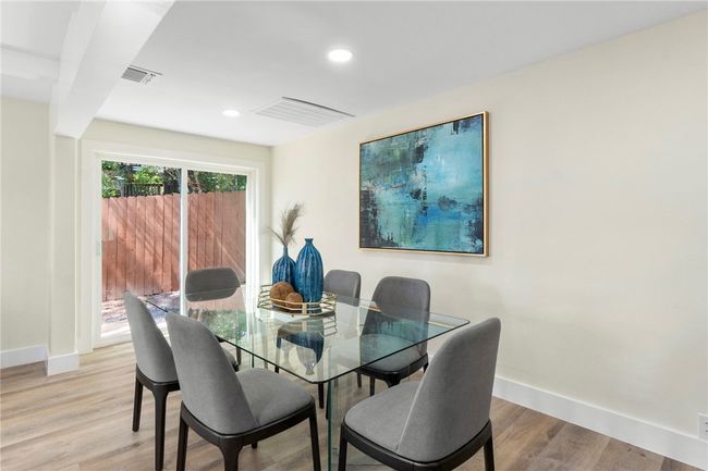 The sliding glass doors off the dining room offer an easy transition from indoor to outdoor living and entertaining. | Image 12