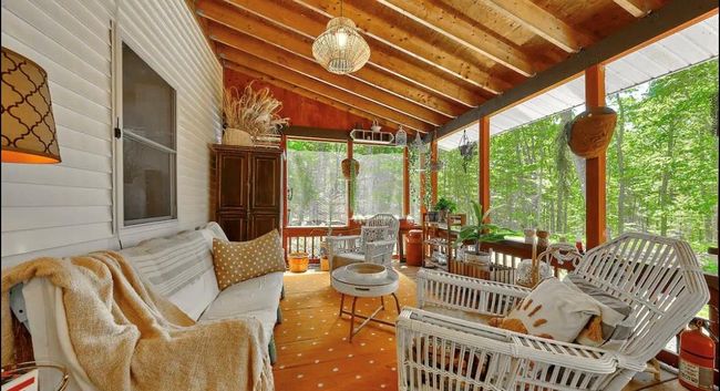 Sunroom / solarium with lofted ceiling with beams | Image 16