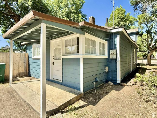 View of home's exterior featuring a chimney and a patio area | Image 28