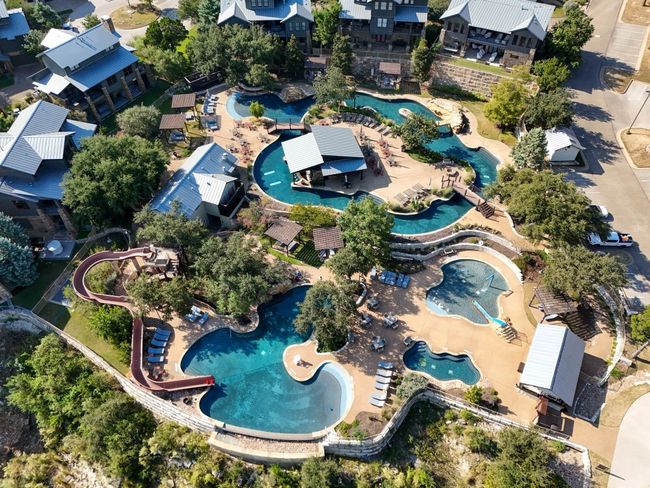 The Reserve offers exclusive resort-style amenities, including an infinity pool, lazy river, lakeside lodge, tennis courts, a private dock, a fish pond, and the Barn for community events. | Image 34