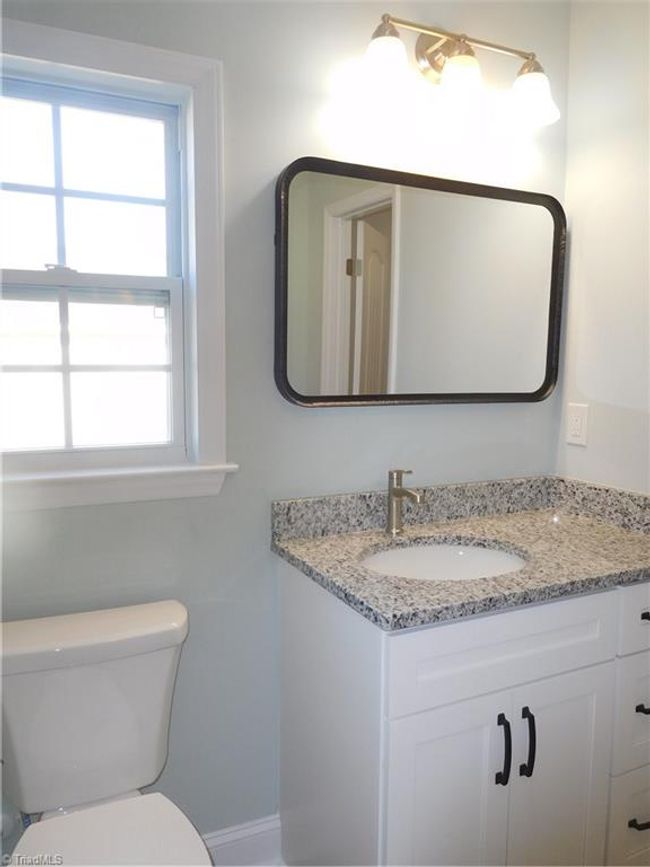 Primary Bathroom. Window provides additional light. Granite top vanity. | Image 17