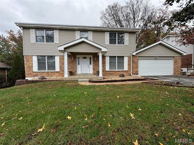 View of front property with a garage, a front yard, and a porch | Image 43