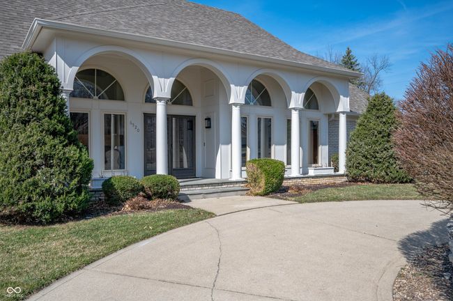 view of front of home with stucco siding, covered porch, and a shingled roof | Image 4