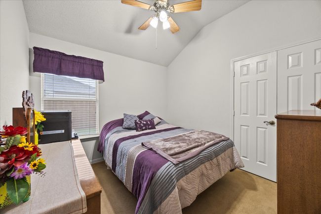 Carpeted bedroom featuring lofted ceiling and a ceiling fan | Image 24