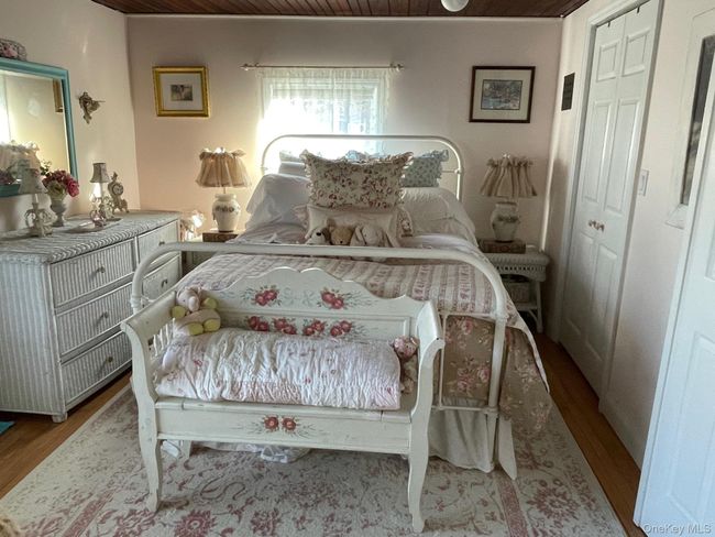 Bedroom with wood ceiling, wood finished floors, and a closet | Image 7