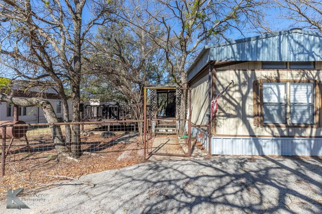 View of home's exterior featuring a gate and fence | Image 5