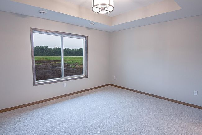 Primary Bedroom boasts a tray ceiling | Image 8