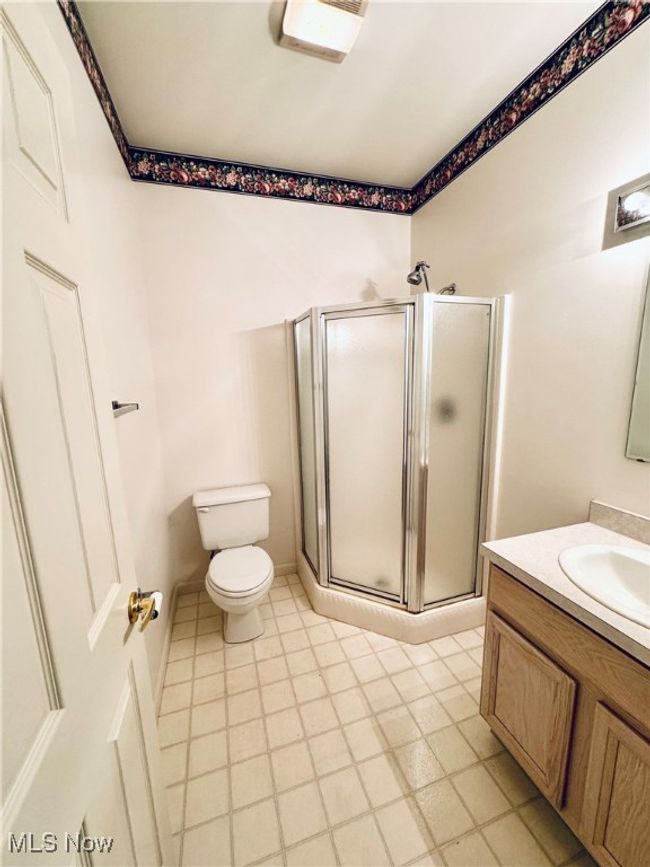 Full bath with a shower stall, toilet, and vanity | Image 20