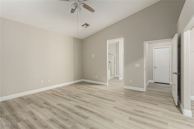Master bedroom with a ceiling fan, light wood-type flooring and lofted ceiling | Image 17