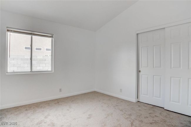 Bedroom with lofted ceiling, & a closet | Image 25