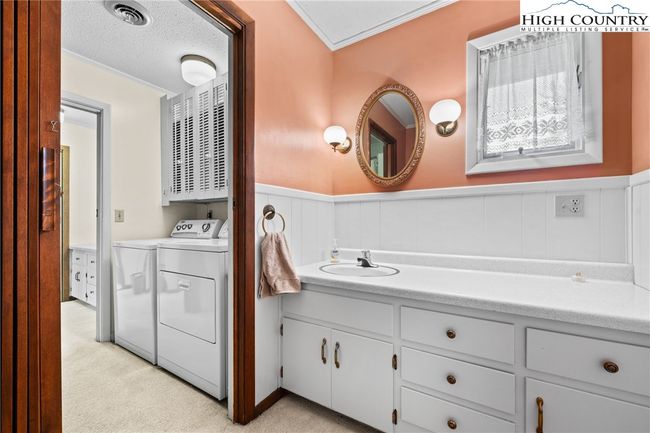 Additionally, the half bath also has access to the laundry. | Image 11