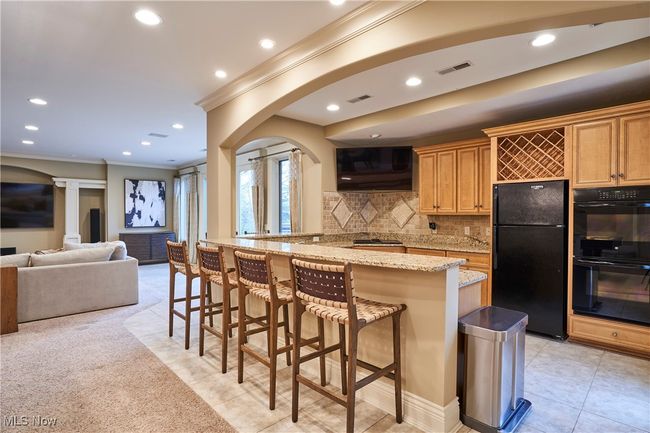 Second Kitchen in the lower level with maple cabinets, granite bar , fully applianced and tile floor. This is great space for entertaining or a teen/in-law suite! | Image 34