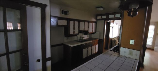 Kitchen featuring light tile patterned flooring and light countertops | Image 8